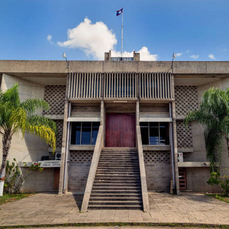 The National Assembly Building in Belmopan, Belize, March 2012. Notice how the architecture was designed to resemble a pre-colombian Maya temple. 

In 1970 the capital of Belize was reestablished in Belmopan in response to the near destruction of Belize City in 1961 by Hurricane Hattie. Belmopan, the "Garden City" is a planned city, so most of the buildings are the same age.

Side note: Belize is a parliamentary constitutional monarchy; Queen Elizabeth II is technically the Queen of Belize!